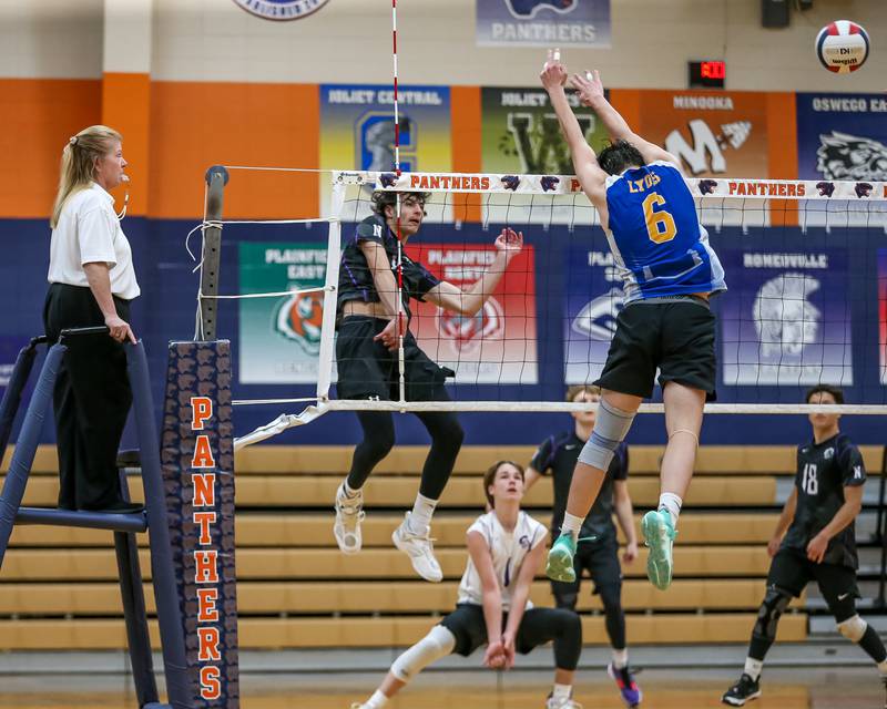 Downers Grove North's Aiden Akkawi (11) spikes the ball past the defense during Oswego Sectional final between Downers Grove North on Tuesday, May 30, 2023.