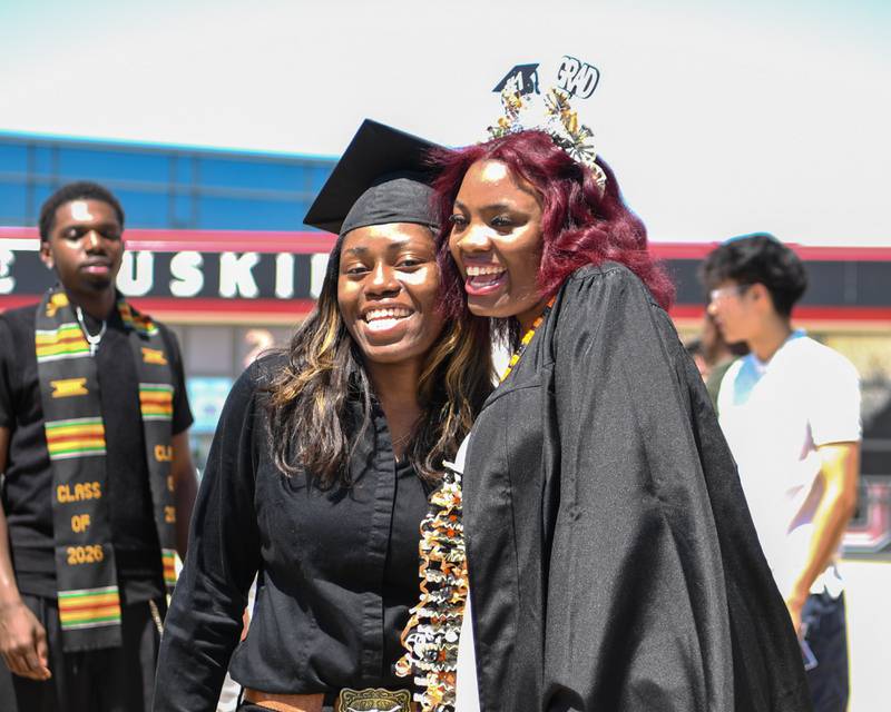DeKalb High School graduates Angela Gary (left) and Zaila Lucas pose for a photo after the graduation ceremony on Saturday, May 23, 2026, held outside the Convocation Center in DeKalb.