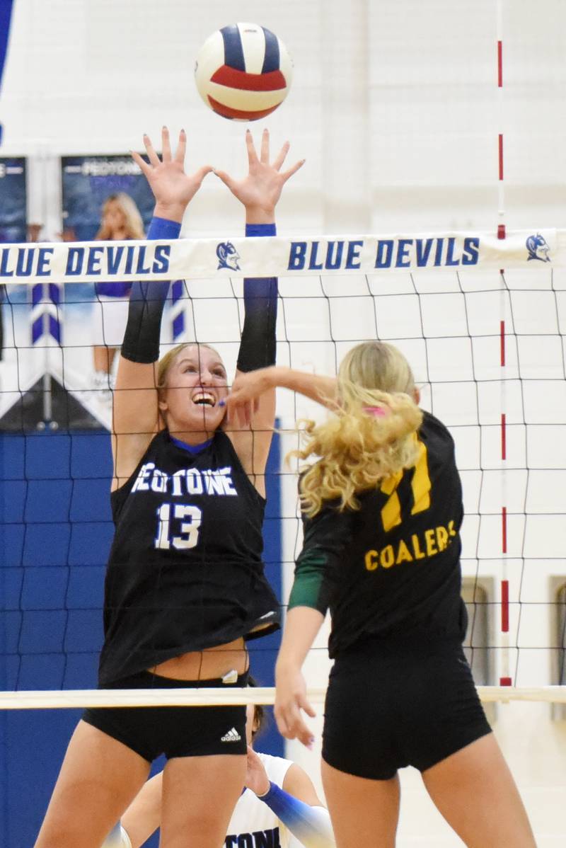 Peotone's Mia Connolley, left, looks to block a hit from Coal City's Maggie Carlson during a game at Peotone Thursday, Sept. 18, 2025.