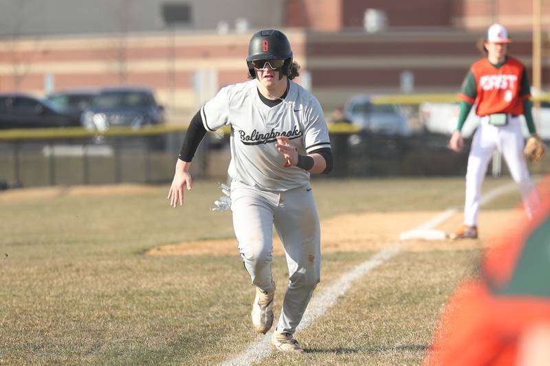 Bolingbrook’s Julian Roasles looks to score on a wild pitch against Plainfield East on Monday, March 27, 2023.