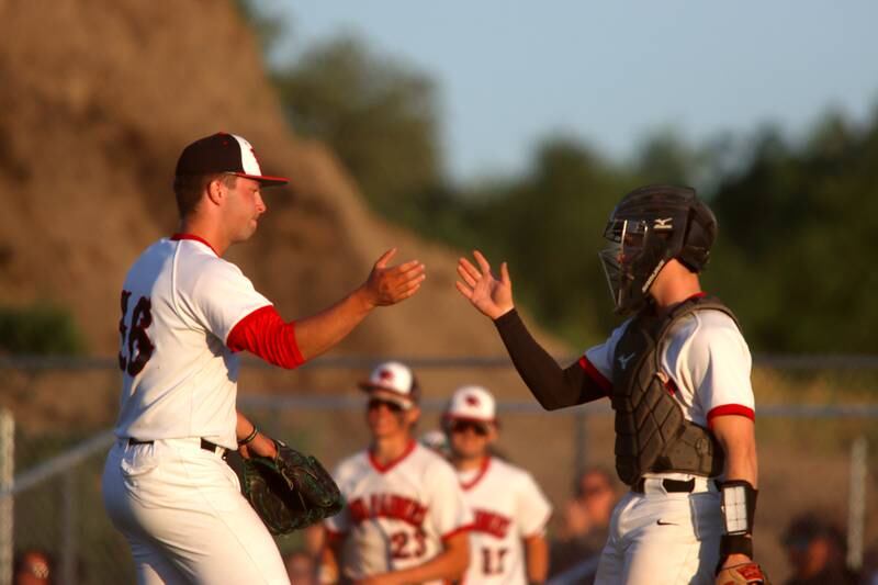 Huntley pitcher Malachi Paplanus, left, and catcher Quinn Drews celebrate a win over Barrington in sectional semifinal baseball action at Hampshire Wednesday.