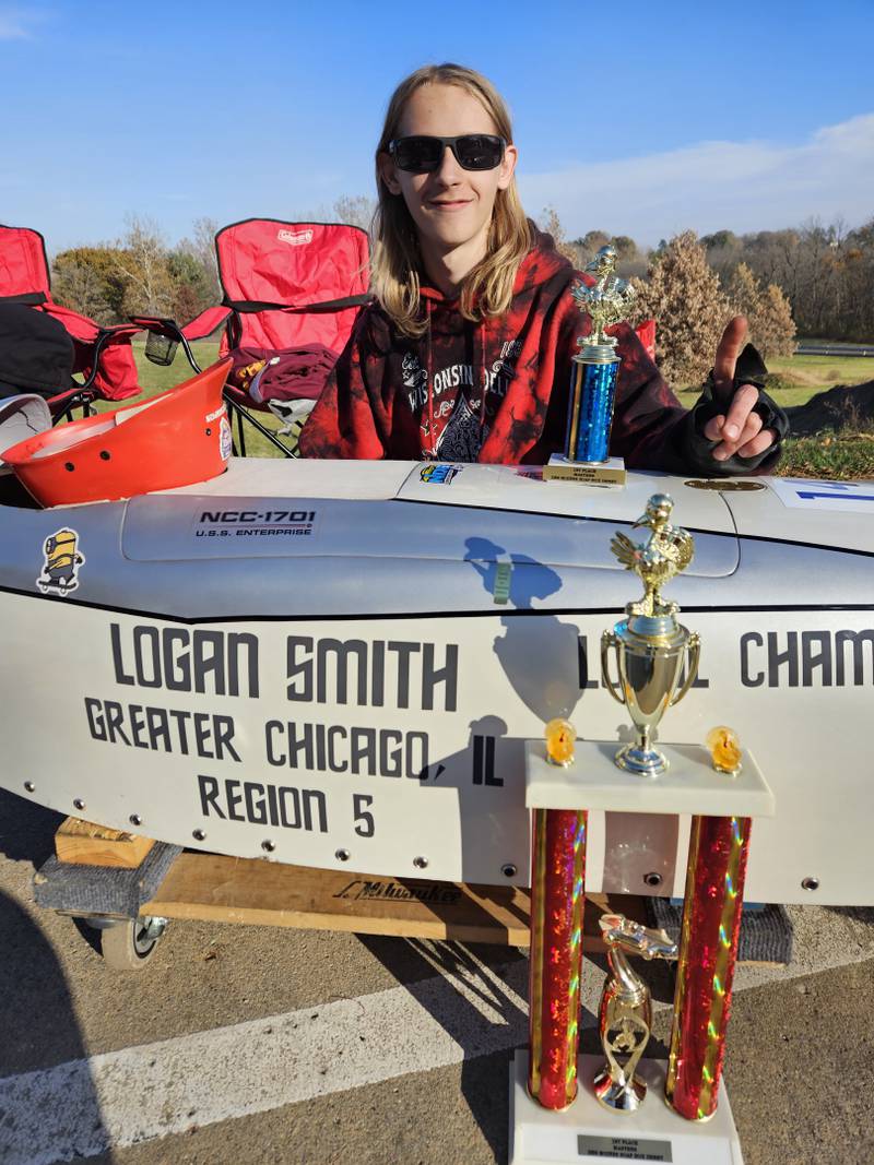 Logan Smith, 16, poses with some of his soapbox derby racing trophies.