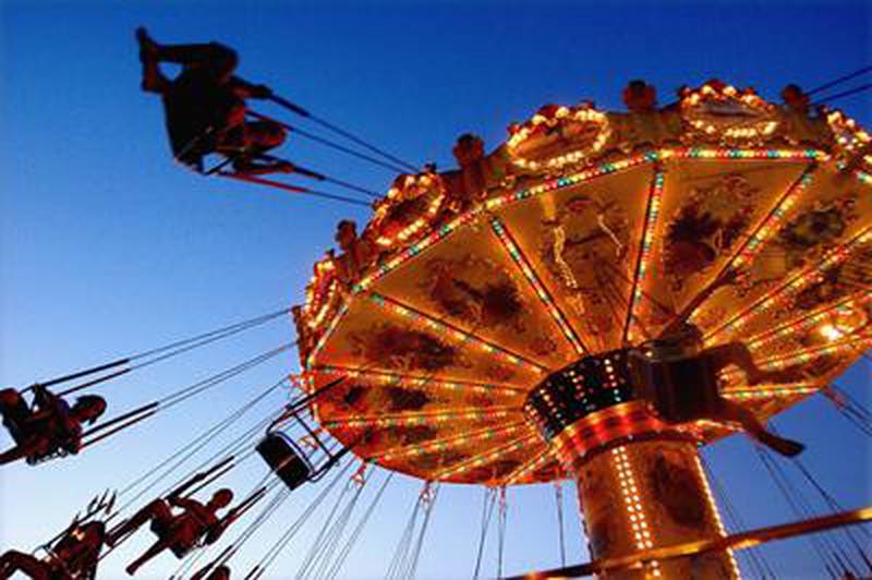 An Aug. 13, 2007 file photo shows visitors enjoying a ride at the Illinois State Fair in Springfield, Ill. Organizers of the Illinois State Fair in Springfield say the theme of this year's 11-day event is family tradition. But it might as well be affordability. With gas prices around $4 a gallon, fair officials hope the $3 daily admission and a list of free activities draw visitors from across the state. This year's fair runs from Aug. 7 through Aug. 17. (AP Photo/Seth Perlman, File)