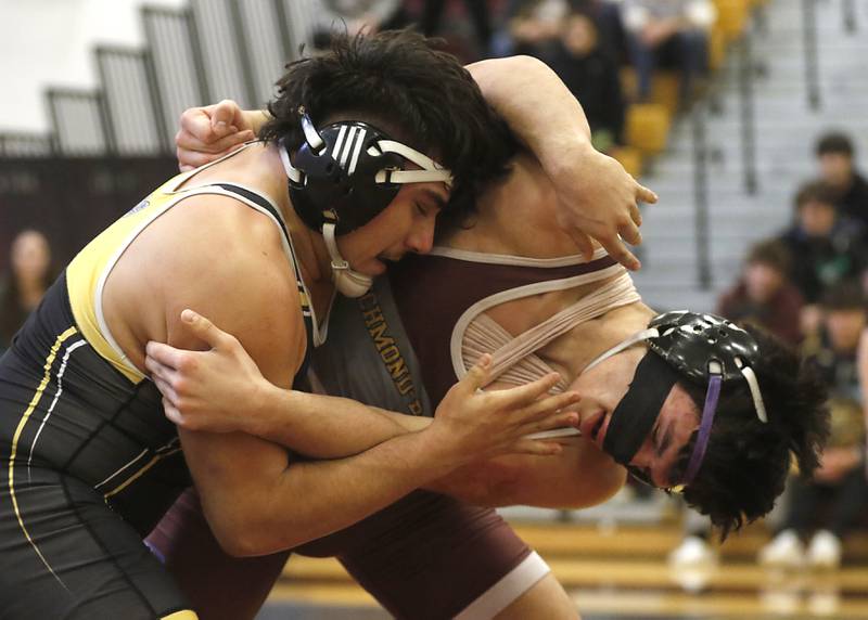Harvard’s Gabe Sanchez and Richmond-Burton’s Alex Reyna battle for control in  their 182-pound championship wrestling match in the IHSA 1A Richmond-Burton Wrestling Regional Thursday, Jan. 19, 2023, at Richmond-Burton High School in Richmond.