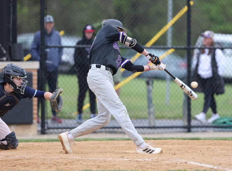 Downers Grove North's Jude Warwick (13) hits the ball during the varsity baseball game between Downers Grove South and Downers Grove North in Downers Grove on Saturday, April 29, 2023.