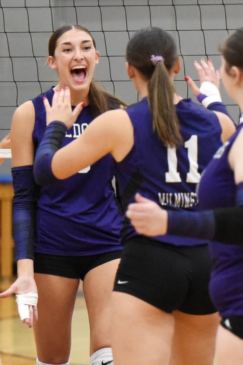 Wilmington's Makenzie Rodriguez, left, celebrates a point with teammate Molly Southall during a game at Manteno Tuesday, Oct. 7, 2025.