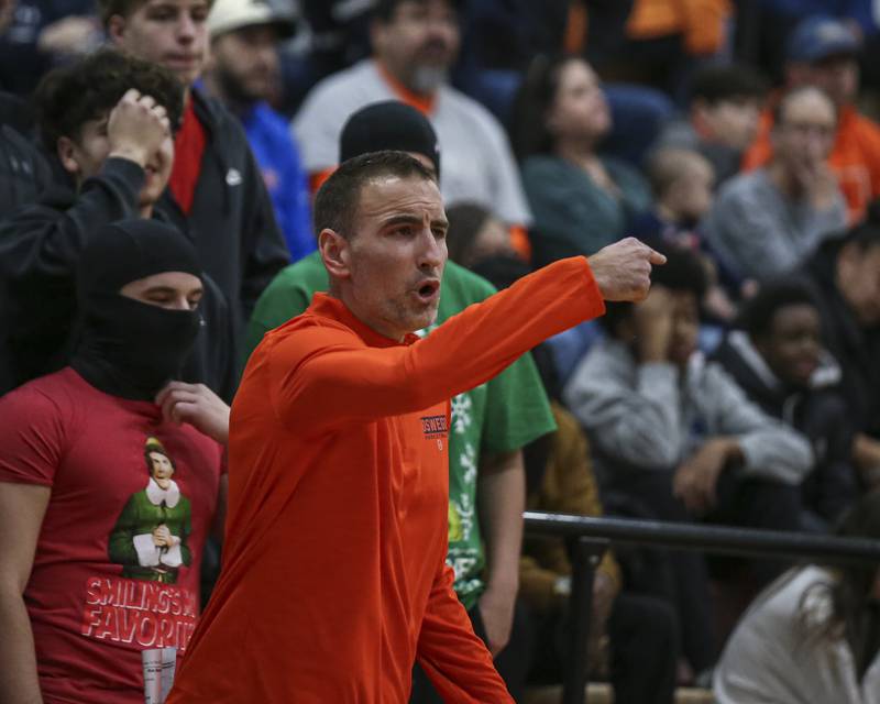 Oswego's head coach Nick Oraham yells out instructions during their basketball game between Oswego at Yorkville Friday, Dec 12, 2025 in Yorkville.