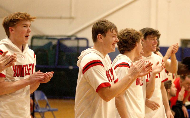 Huntley’s Red Raiders cheer teammates against Crystal Lake Central during tournament basketball action at Johnsburg High School Monday evening.