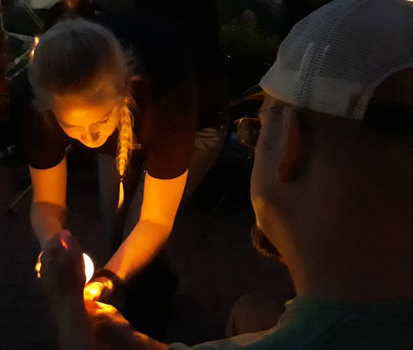 Waypoint Vets founder Sarah Lee, of the Nashville, Tennessee area, lights a candle Saturday, Aug. 13, 2022, during a vigil at the Middle East Conflicts Wall in Marseilles.