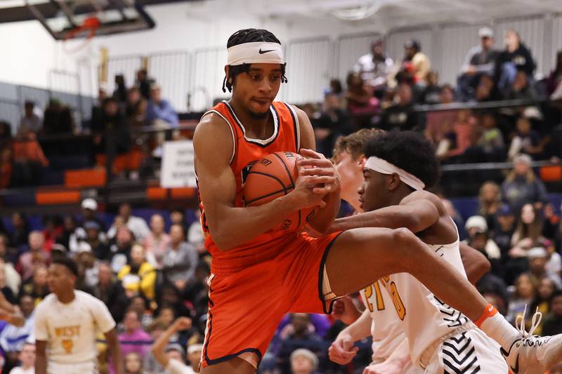 Romeoville’s Troy Cicero Jr. pulls in the defensive rebound against Joliet West on Tuesday January 31st, 2023.