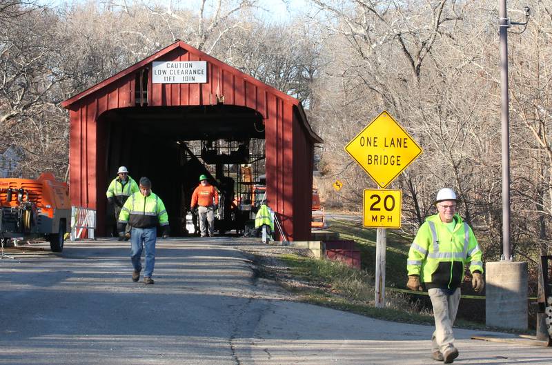 An Illinois Department of Transportation crew begins repairs on the Red Covered Bridge on Monday, Dec. 11, 2023 in Princeton. The bridge was severely damaged when it was struck by a semi truck on Nov. 16.