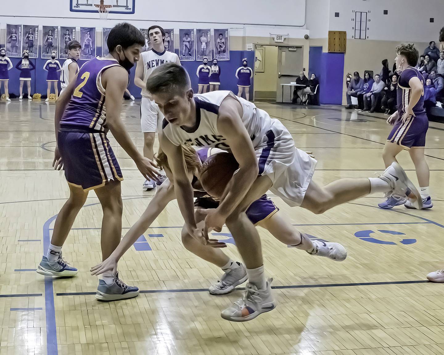 Newman's Owen McBride tries to corral a loose ball against Mendota during their Three Rivers East game Friday night in Sterling.