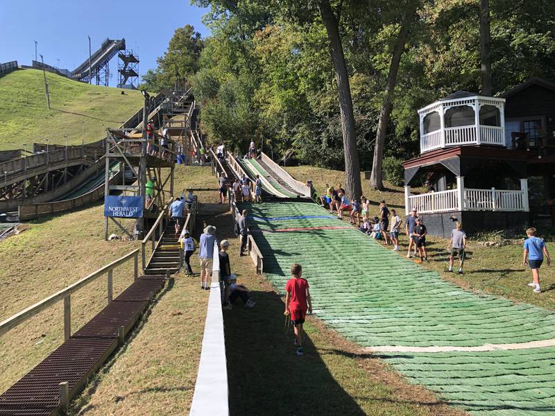 The first jumpers on Saturday, Oct. 4, 2025, at Norge Ski Club's annual Jumptoberfest tournament. Athletes - including to children just entering the sport- jumped on all of the hills in 80-degree weather.