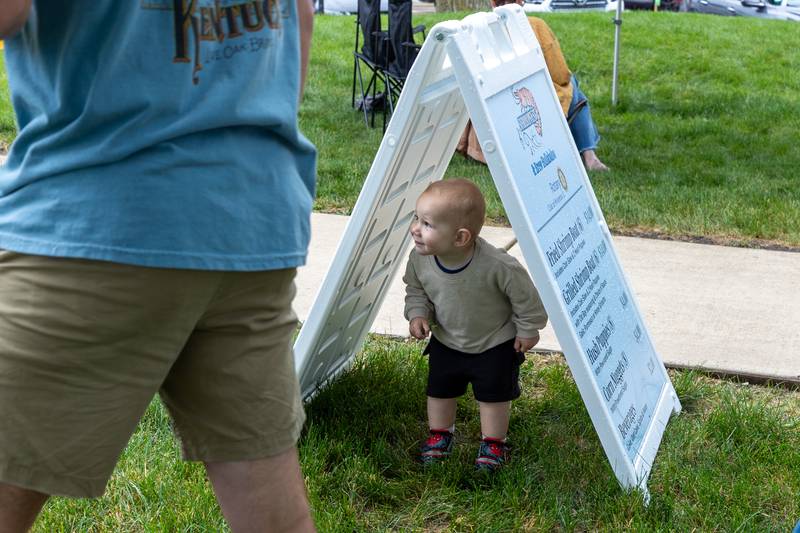 Everett Eckberg peeks from under sign during the annual Shrimp Fest on Saturday, June 7, 2025 at Rotary Park in Princeton.