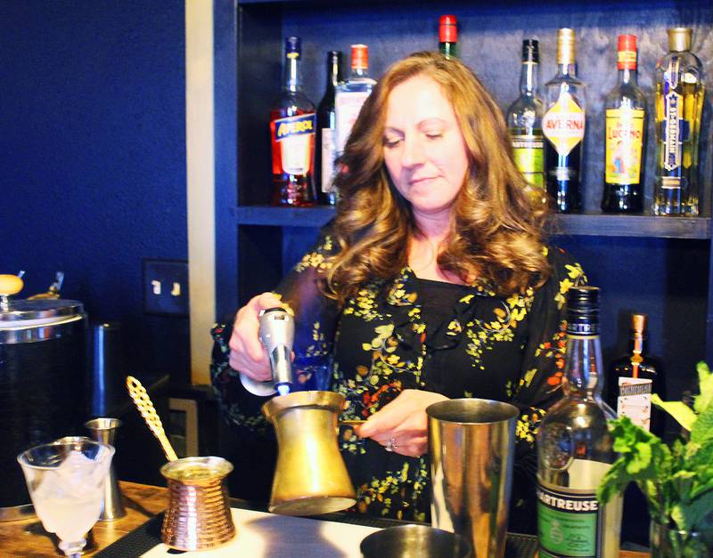 Mix master Michelle Hasankolli makes a drink at The Wolf Den in Pearl City.