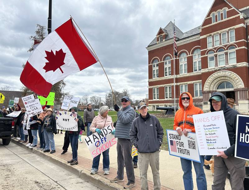 One of the 400 participants who took part in the Hands Off rally held a Canadian flag. The rally was held around the historic Ogle County Courthouse in Oregon on Saturday, April 5, 2025.