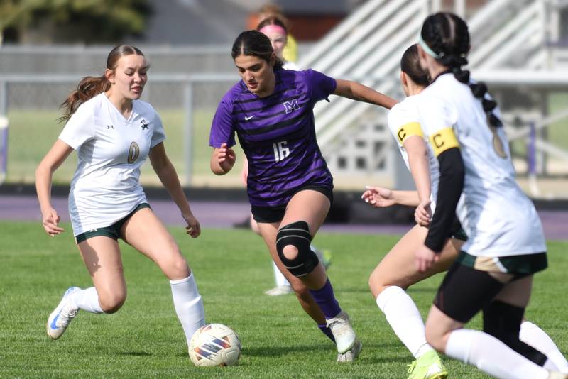 Manteno's Michelle Carrera (16) dribbles through a trio of Bishop McNamara defenders during a home game Wednesday, April 29, 2026.