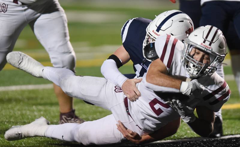 Joe Lewnard/jlewnard@dailyherald.com
Wheaton Academy's Brandon Kiebles scores a touchdown as St. Viator Allistar Kanyuh tries to make a tackle during Friday’s Class 4A football playoff game in Arlington Heights Friday.