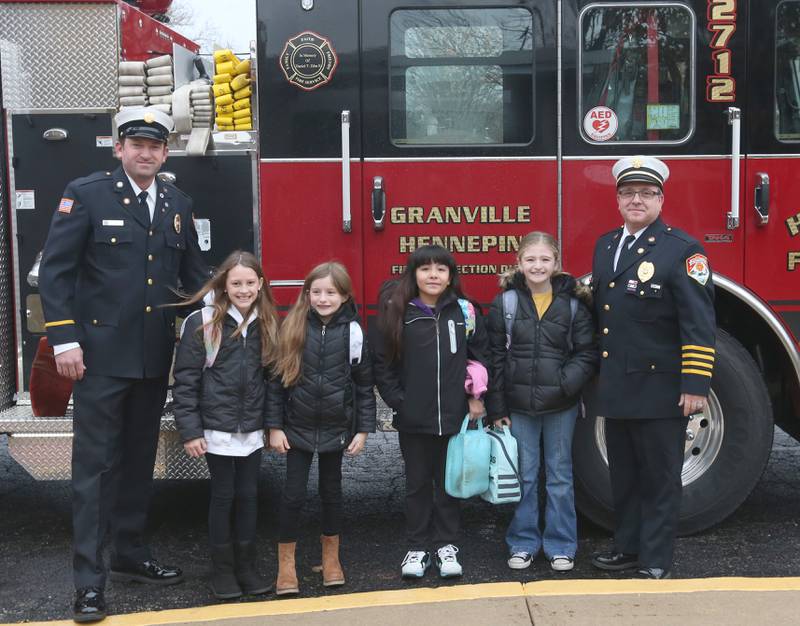 Putnam County Elementary students (from left) Krya King,  Giada Wright, Priscilla Serna and Octavia Walter, pose for a photo with lieutenant Tyler Smith and deputy chief Quentin Buffington Tuesday, Nov. 21, 2023 at Putnam County Elementary School in Hennepin. The students won the Escape Floor Plan contest held by the fire depatment. Students had to draw a floor plan or map of their home showing all doors and windows. Smoke alarms had to be marked in each plan. A family meeting place was also required to be marked on the drawings. Winners were awarded Amazon gift cards. The Hennepin Fire Department has been holding the contest for several years. The department stopped the event during Covid and continued it for the first time since the pandemic this year. The department picks the winning children up on a firetruck and busses them to school.