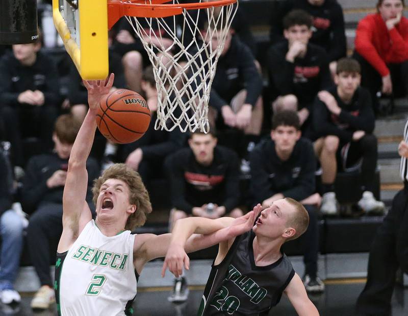 Seneca's Kenny Daggett is fouled by Midland's Jacob Spicer as he drives to the hoop during the Tri-County Conference Tournament on Thursday, Jan. 25, 2024 at Putnam County High School.