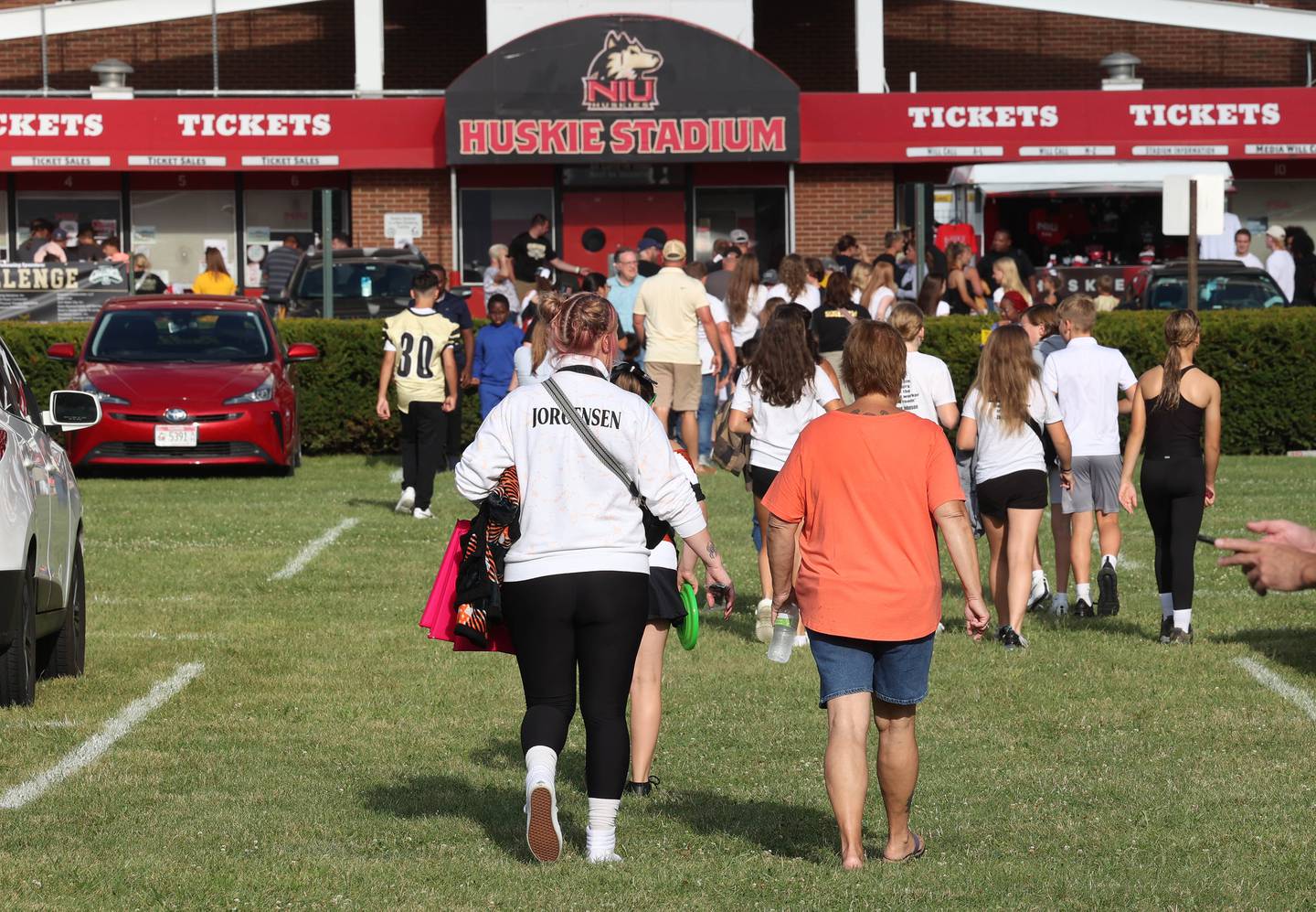 DeKalb and Sycamore fans leave the tailgate and head into the stadium Friday, Aug. 30, 2024, before DeKalb, Sycamore football game in the the FNBO Challenge at Huskie Stadium at Northern Illinois University.