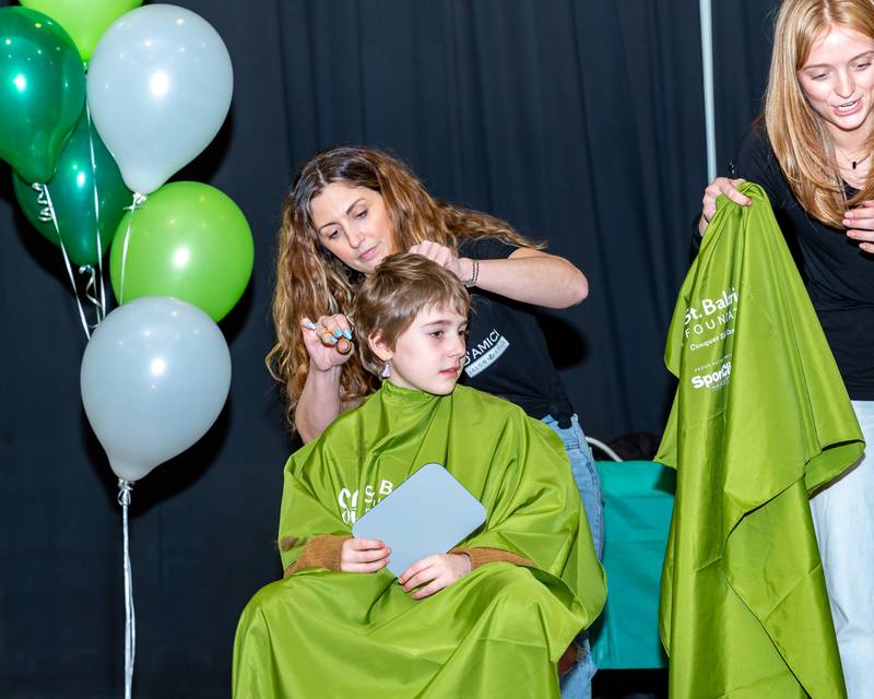 Gwen gets her hair clipped at the St Baldricks Foundation event for Gwen Cola at Forest Road Elementary School in La Grange Park. March 23, 2023.
