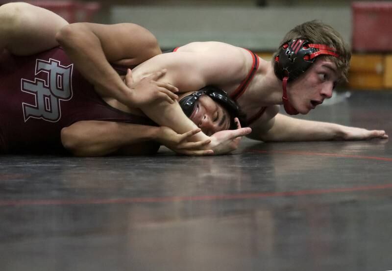 Huntley’s Waylon Theobald, top, battles Prairie Ridge’s Aiden Rodriguez at 175 pounds in varsity wrestling on Thursday, Jan. 23, 2025, at Huntley High School in Huntley.