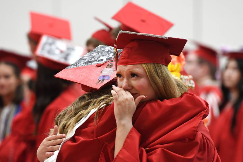 Oregon High School graduate Keltie Champley hugs classmate Paloma Albaugh at the start of the Class of 2026 commencement ceremony at the Blackhawk Center in Oregon on Sunday, May 24, 2026.