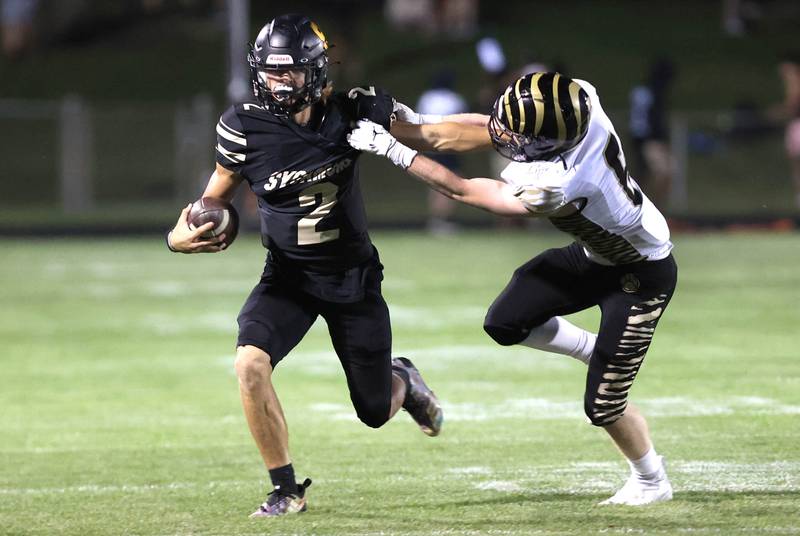 Sycamore's Elijah Meier attempts to fend off the tackle of Oak Forest's Joe Castaneda during their game Friday Sept. 2, 2022, at Sycamore High School.