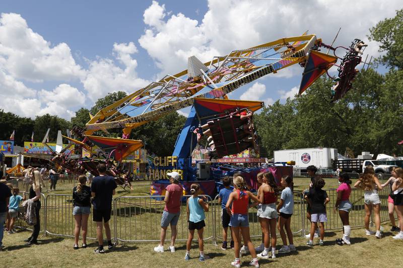 People wait to ride on the Cliff Hanger during Lakeside Festival on Thursday, July 3, 2025, on the grounds of the historic Dole Mansion in Crystal Lake,