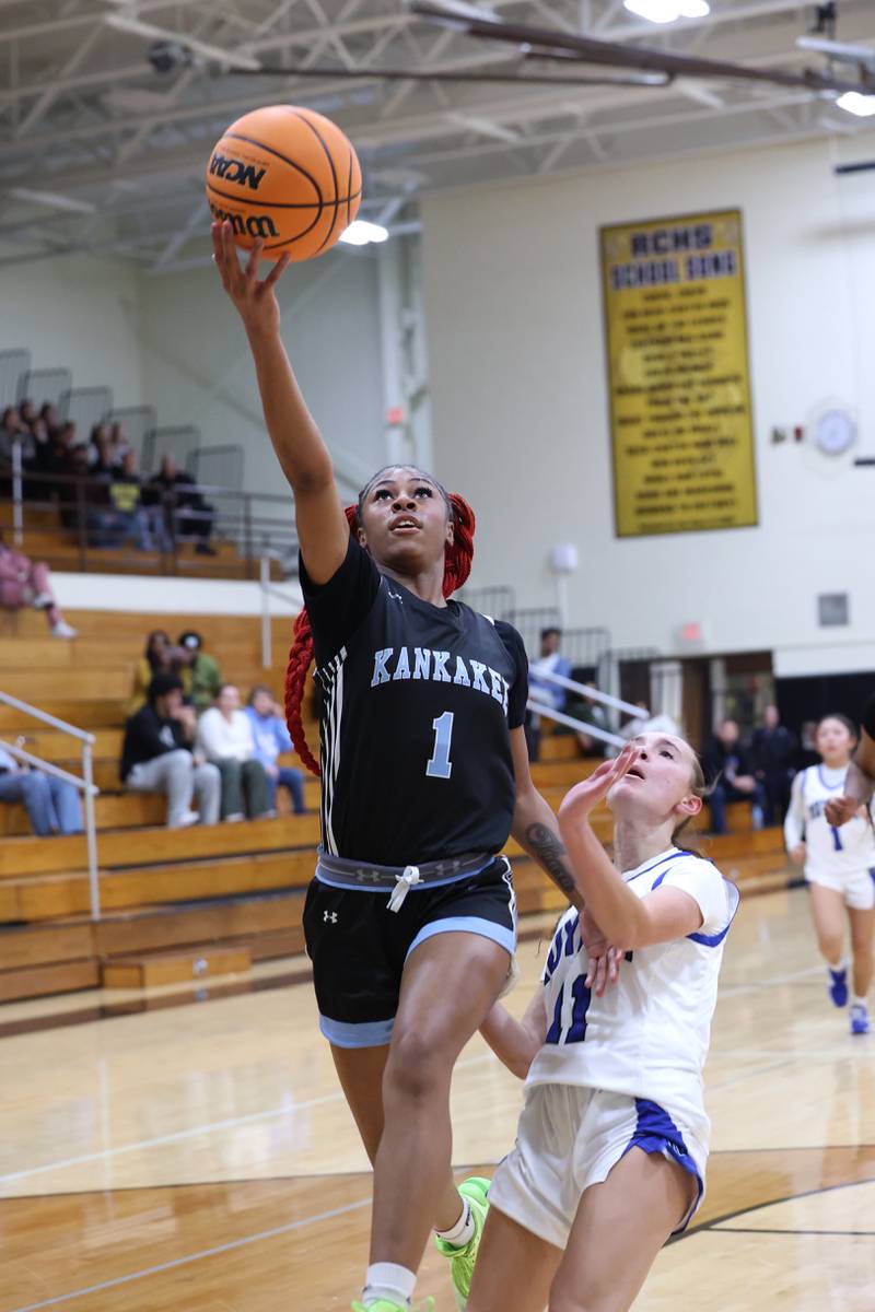 Kankakee's Ki'Asia Wilson goes for a layup past Rosary's Zoe Mesner during the Kays' 75-28 victory over Rosary at the Reed-Custer Classic on Monday, Nov. 17, 2025.