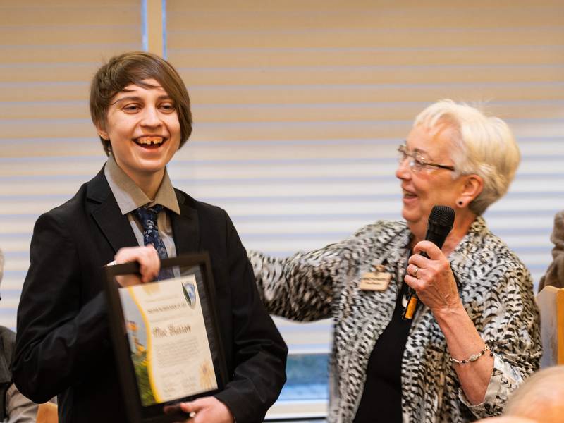 Environmental Defenders of McHenry County board member Nancy Shietzelt presents Mac Hansen the Young Defender Award on Sunday March 13, 2022, at the McHenry Country Club.