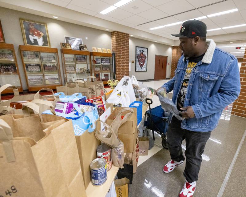 Demarcus Ellis drops off a food donation prior to the start of TubaChristmas on December 15, 2024 at Hall High School.