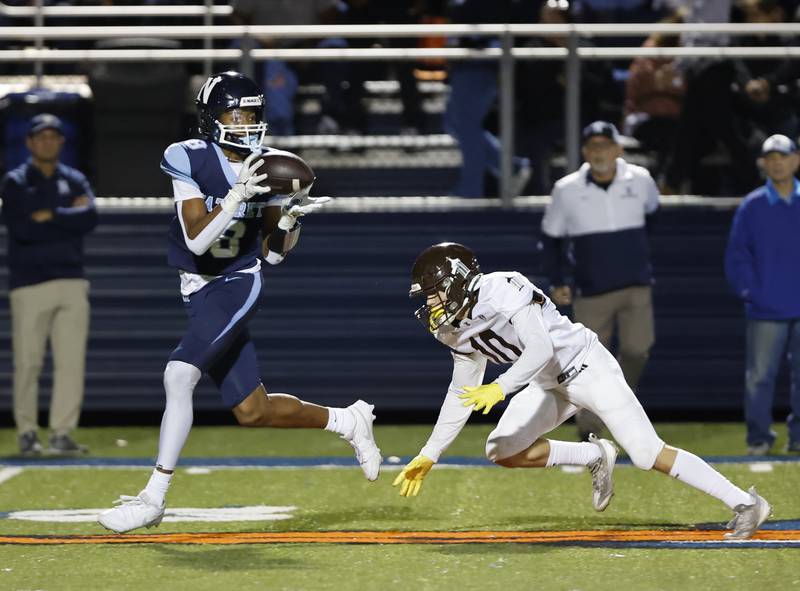 Nazareth's Trenton Walker (8) makes a reception during the varsity football game between Joliet Catholic and Nazareth academies on Friday, Sep. 27, 2024 in La Grange Park.