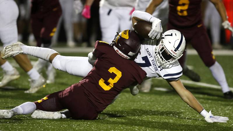 St. Viator's Michael Tauscher is tackled by Richmond-Burton's Oscar Bonilla during a IHSA Class 4A first round playoff football game Friday, Oct. 27, 2023, at Richmond-Burton High School in Richmond.