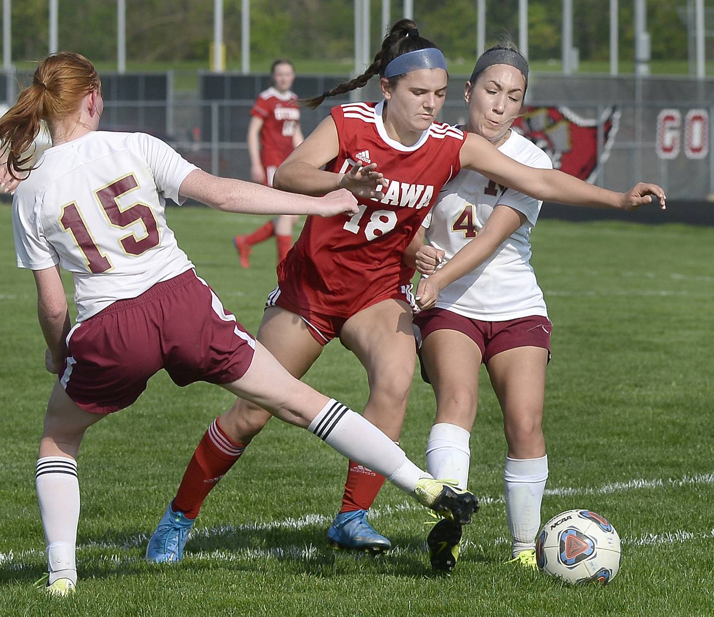 Ottawa’s Gabi Krueger splits the Morris defense of Makensi Martin and Adriana Placsencia  in the first half of soccer match Tuesday, May 10, 2022, at Ottawa.