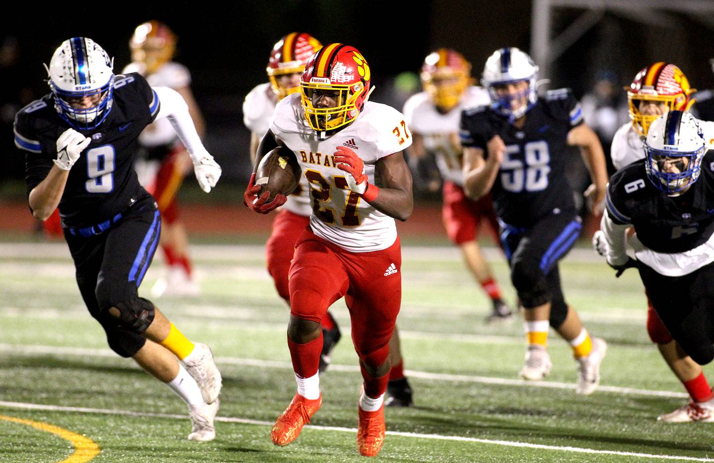 Batavia's Jalen Buckley runs the ball for a touchdown during a game at St. Charles North on Friday, Oct. 22, 2021.