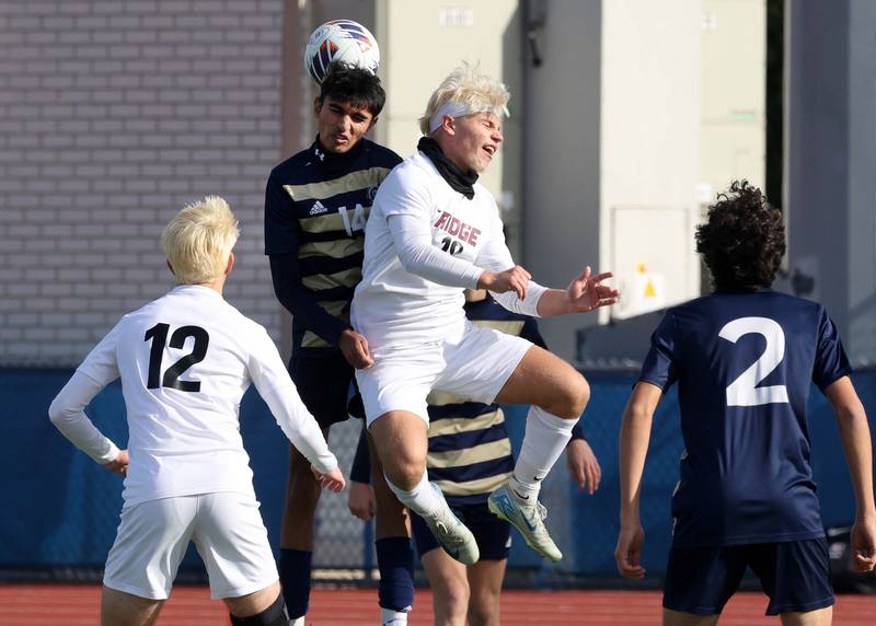 Lemont's Faraz Ayub (left) and Prairie Ridge's Gabriel Porter go up for a header Saturday, Nov. 9, 2024, during their Class 2A state third place game at Hoffman Estates High School.