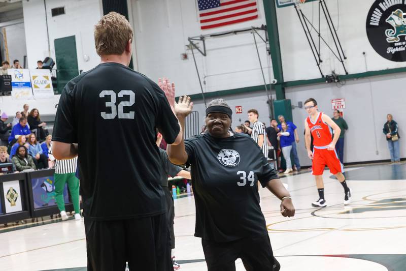River Valley Special Rec player Vera Scott, right, congratulates teammate Shane Holdosh on his 3-pointer in their game against Lincolnway Special Recreation Association at Bishop McNamara on Friday, Jan. 30, 2026.