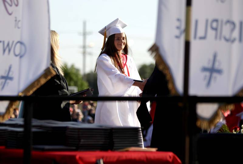 Benet graduate Ava Bechstein walks across the stage during the school’s commencement ceremony in Lisle on Thursday, May 25, 2023.