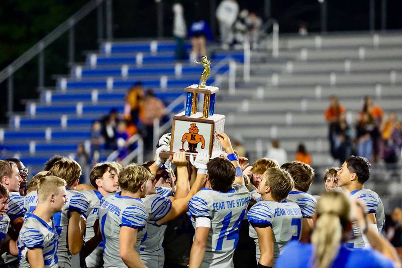 Princeton Tigers hoist the traveling trophy after the Tigers' 63-12 win over Kewanee on Friday.