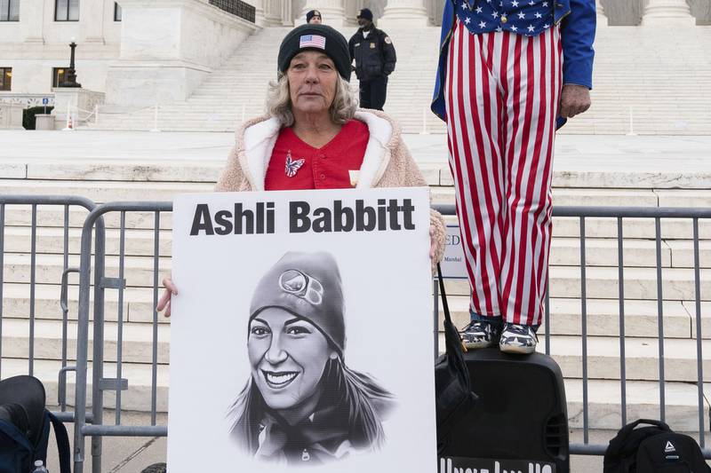 FILE - Micki Witthoeft, center, mother of Ashli Babbitt, the woman fatally shot by police inside the U.S. Capitol during the Jan. 6, 2021, riot, joins protesters outside of the Supreme Court on the second anniversary of the Jan. 6, assault on the U.S. Capitol, in Washington, Jan. 6, 2023. (AP Photo/Jose Luis Magana)