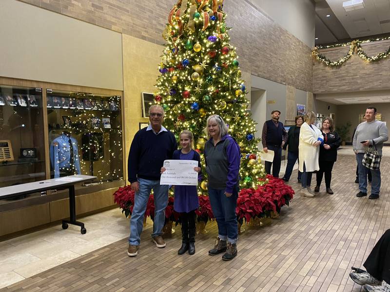 Clare W. donates $1,000 to Just Animals of Mazon as a winner in the Community Foundation of Grundy County's essay contest.