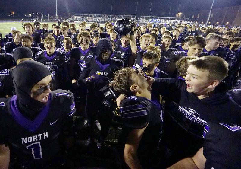 Downers Grove North's Jonathan Nelson (3) and his teammates celebrate their win after the IHSA Class 7A playoff football game Friday, Oct. 31, 2025 in Downers Grove.