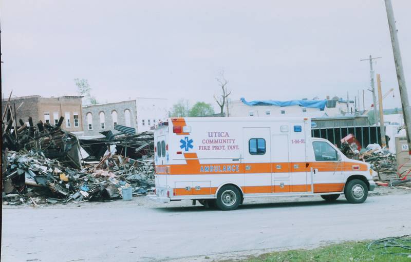 A Utica ambulance is parked near the rubble of the Milestone Tap on Wednesday, April 21, 2004 in Utica.