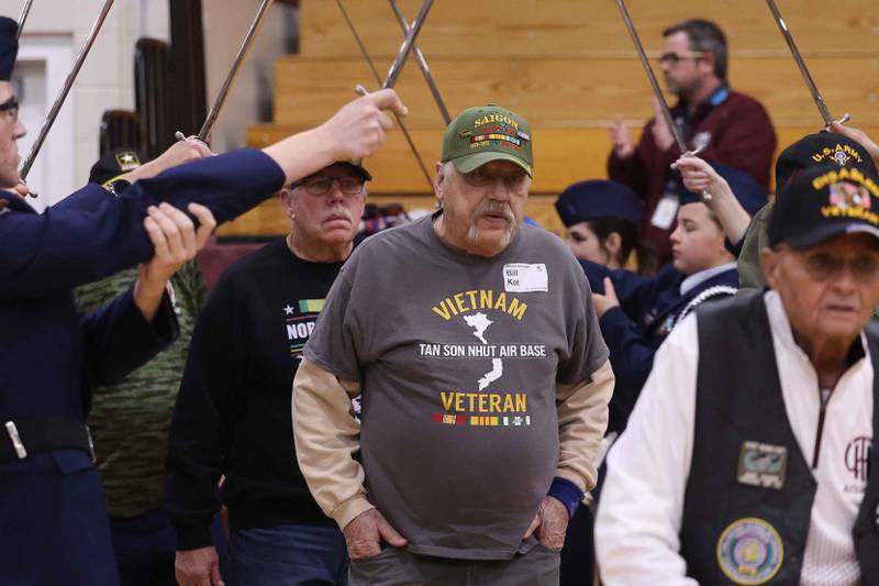 Veteran Bill Not and other military veterans are lead into the gymnasium at the Lockport Township High School 10th Annual Veterans Night Celebration on Friday, Dec. 6, 2024.