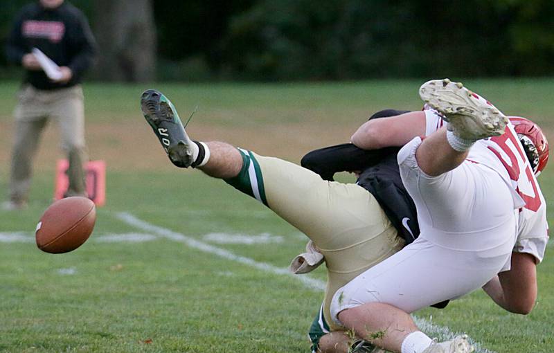 Hall's Joel Koch (57) sacks St. Bede's quarterback John Brady as the ball comes loose on Saturday, Oct. 15, 2022 at the Academy in Peru.