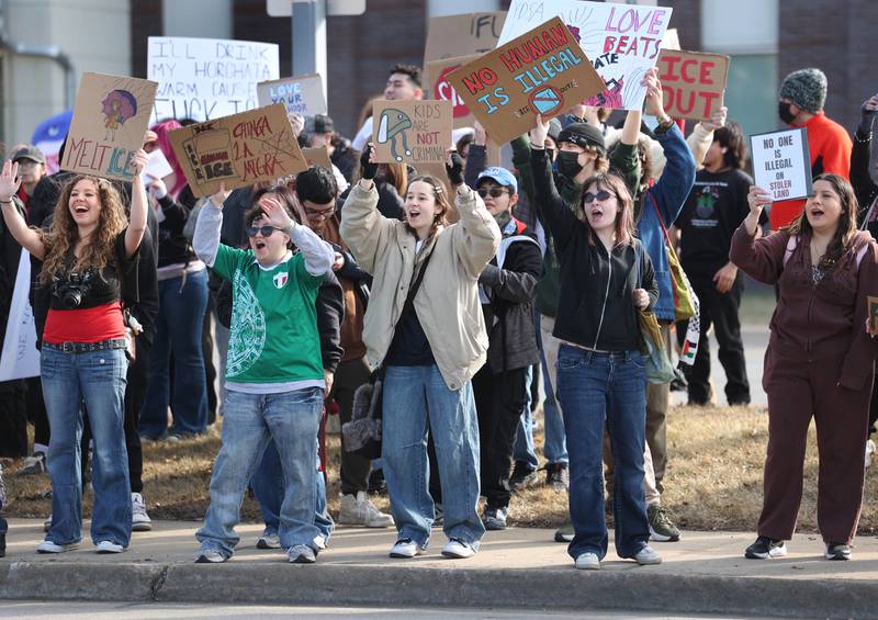 Northern Illinois University students hold signs and chant Friday, Feb 13, 2026, in front of the DeKalb Police Department, during a protest against recent nationwide U.S. Immigration and Customs Enforcement activity.