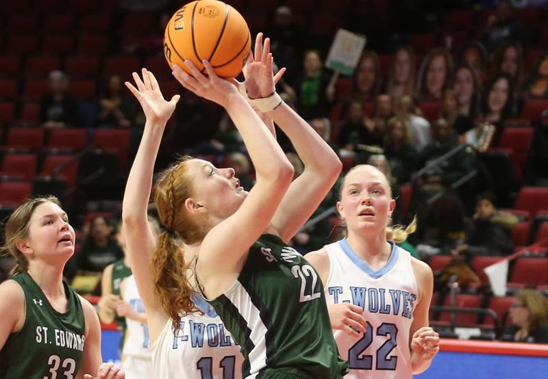 St. Edward's Layne Dawson eyes the hoop as Cissna Park's Sophie Duis and Josie Neukomm defend the lane during the Class 1A third place game on Friday, March 7, 2025 at CEFCU Arena in Normal.
