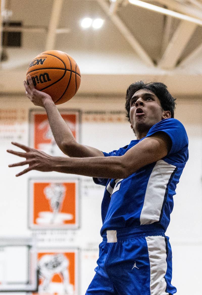 Geneva’s Anish Buddaraju goes up for a layup during an away game against Wheaton Warrenville South High School on Tuesday, Dec. 3, 2024.